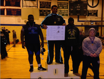 Noah Stanley stands atop the podium after taking first-place in the city-wide individual tournament.  He is the first Mustang city champion since 2009.