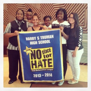 Truman students and buildOn Coordinator proudly pose with the NPFH banner.