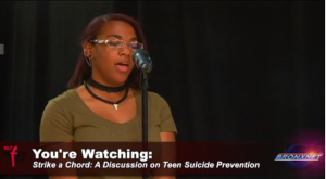 Student Cleopatra Green asks the expert panel a question regarding teen suicide during the Strike A Chord Campaign panel discussion.