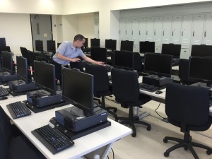 Rodriguez gets another computer lab ready for the next incoming class.
