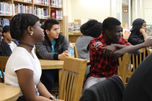 Students listen intently as classmates read their poetry in the Truman Library Wednesday.