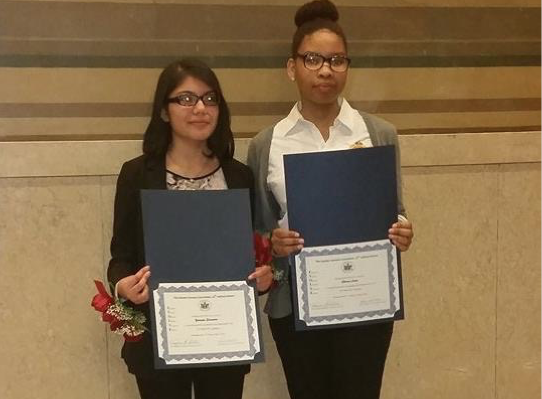 Yessenia Saavedra (l) and Sherece Laine are honored with the EVOLVE Award from the Bronx Supreme Court.