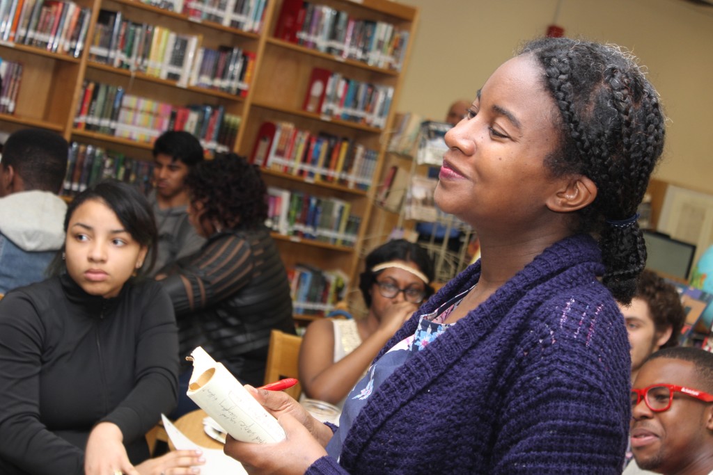 Mariahadessa Ekere Tallie listens as students share their responses to her prompt, "write six words that tell me about who you are."