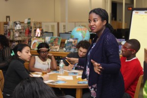 Tallie listen as students discuss their writing during a hands-on workshop Tuesday.