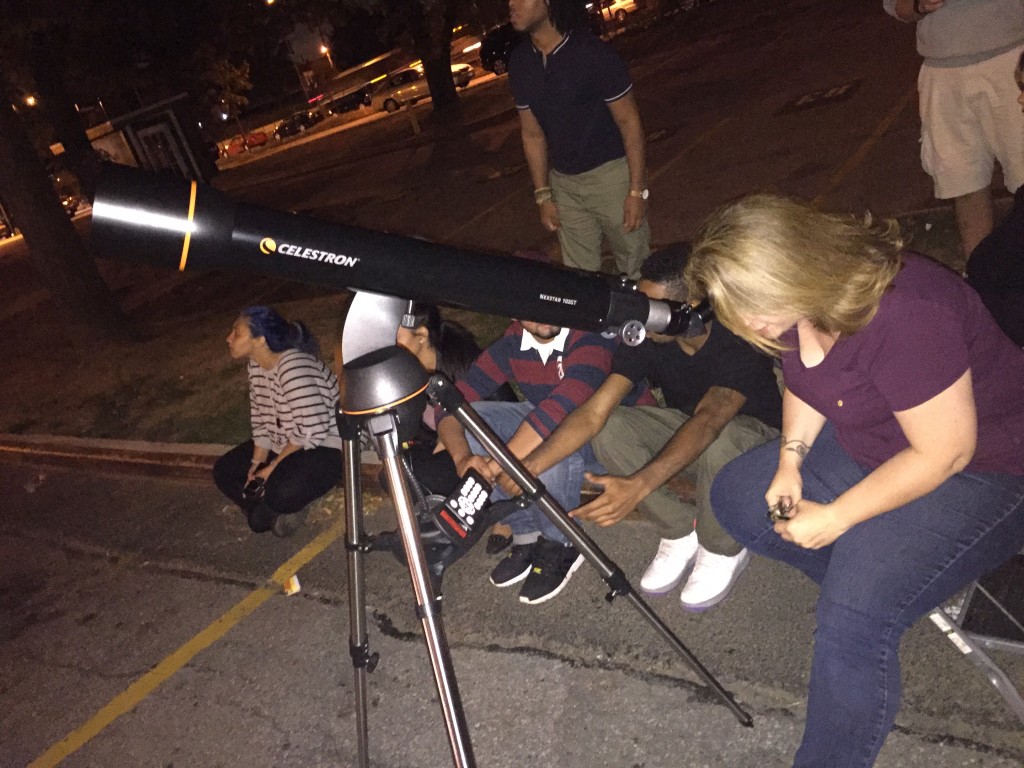 Earth Science and Astronomy teacher Ms. Robbins double-checks the telescope's alignment during Sunday's eclipse.