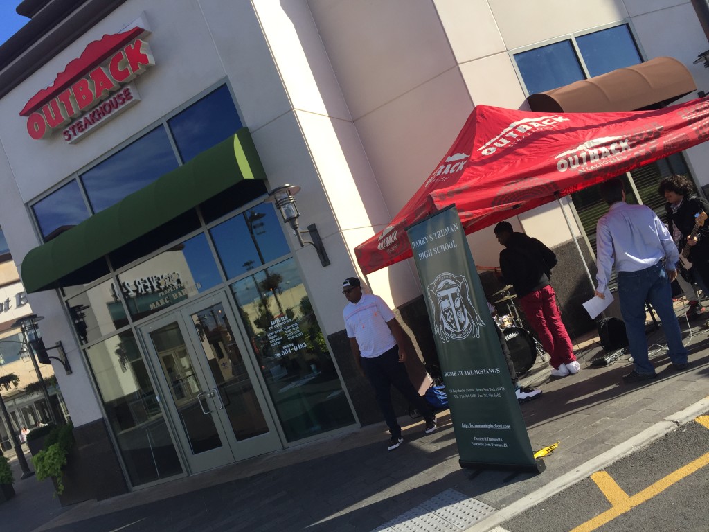 Truman's band plays near the entrance of the Outback Steakhouse for Monday's event.