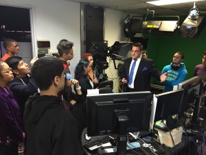 Students listen as Meteorologist Mike Favetta explains how the weather system works at News 12.