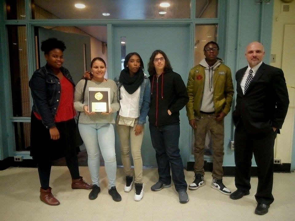 Several law students, with teacher Mr. Zanoni show off the plaque they earned at December's "We The People" competition in Manhattan.