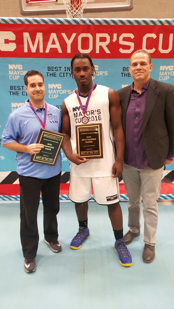 (l to r) Coach Ricardo Furriel, Senior Kevin Dennis and PSAL Sports Coordinator Danny Harris celebrate Dennis receiving MVP honors at the Mayor's Cup Game