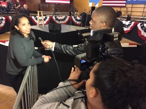 Media senior Daniel Adlam interviews an attendee at the Hillary Clinton rally.