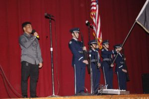 Fred Huertas opens the show with the National Anthem, along side the Air Force JROTC color guard.