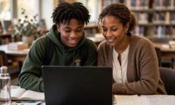 A Truman senior and parent working on a laptop together